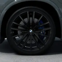 Nahaufnahme eines schwarzen BMW-Rads mit blauen Bremssätteln.