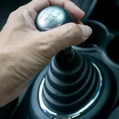Hand schaltet mit der auto kupplung den Gang.