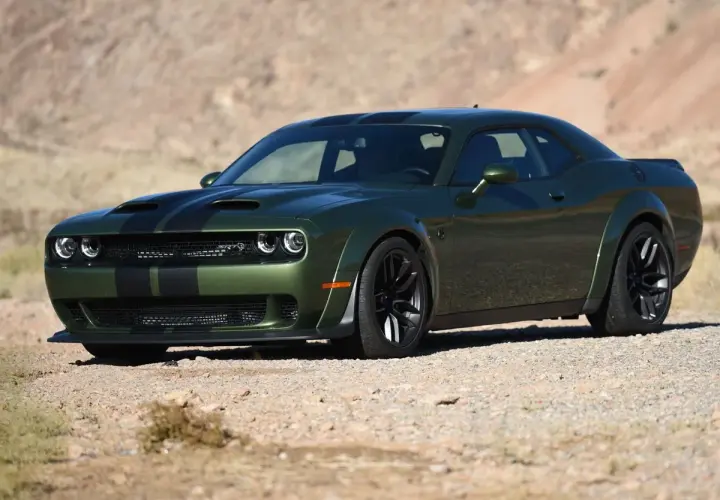 Grüner SRT Demon mit schwarzen Streifen parkt in der Wüste.