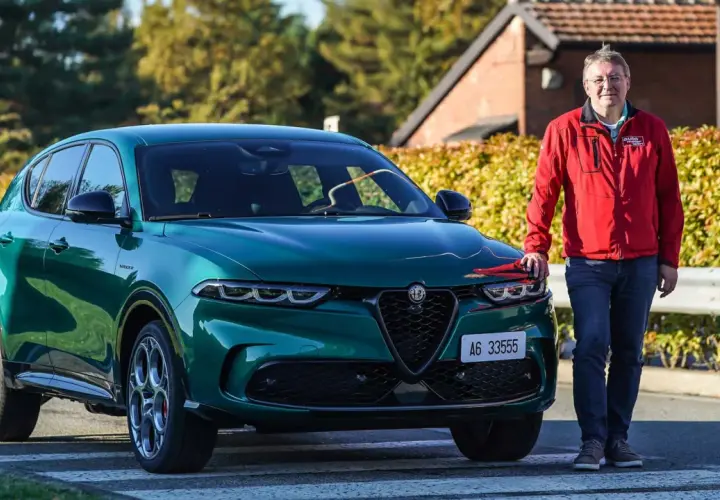 Ein Mann steht neben einem grünen Alfa Romeo Tonale, einem Alfa Romeo Plug-in Hybrid.