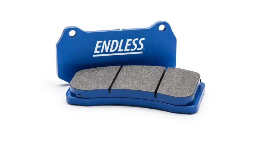 Zwei blaue Endless-Bremsbeläge mit grauem Reibmaterial auf weißem Hintergrund.